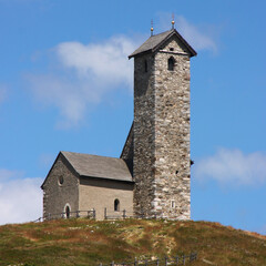 Fototapeta na wymiar Small romanesque mountain church of St Vigil am Joch, Lana village in the Alps, South Tyrol in Italy