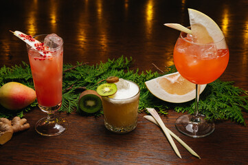 Three exotic cocktails on the table. Sour cocktail, pear cocktail and aperol spritz