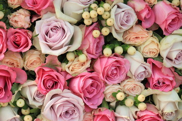 Pink and purple roses in a wedding centerpiece