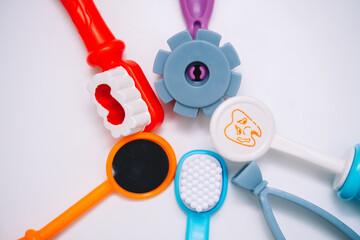 Toy kids dental instruments on white background, kids room in hospital
