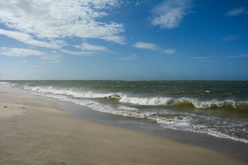 Fototapeta na wymiar Sea and waves with sand beach and blue sky