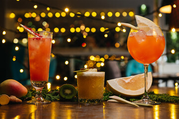 Three exotic cocktails on the table. Sour cocktail, pear cocktail and aperol spritz