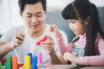 little children playing toys to education with family at home, girl happy and fun in childhood concept