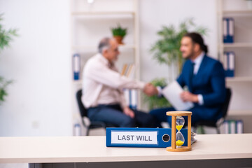 Young male lawyer and old man in testament and time management c