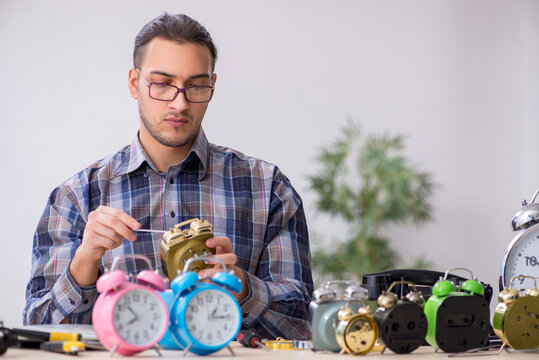 Young male watchmaker working in the workshop