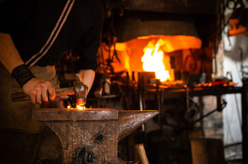 Detail shot of metal being worked at a blacksmith forge