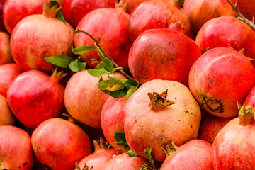Many pomegranates for sale at the market. Fruit background