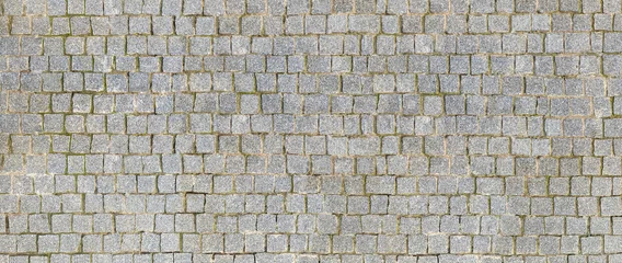 Foto op Aluminium Granite cobblestoned pavement background. Stone pavement texture. Abstract background of cobblestone pavement close-up. Seamless texture. © Heisenberg