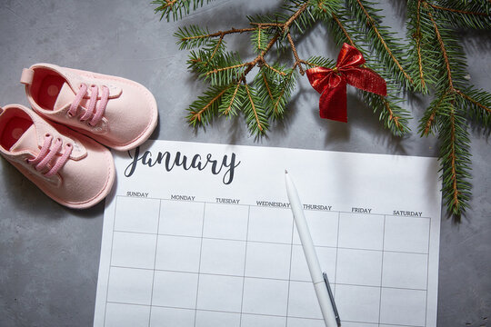Baby's shoes, winter calendar for January. The announcement of the pregnancy.