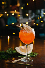 aperol spritz cocktail with pomelo on the table in restaurant