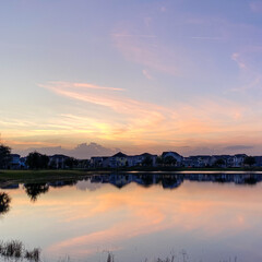 Beautiful pink, orange and blue sunset reflecting on a lake.