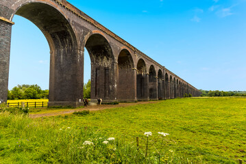 A view along the side of the Harringworth railway viaduct, the longest masonry viaduct in the UK