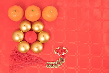 Chinese new year arrangement with table and red background with red and silver decorations, tablecloths and tangerines