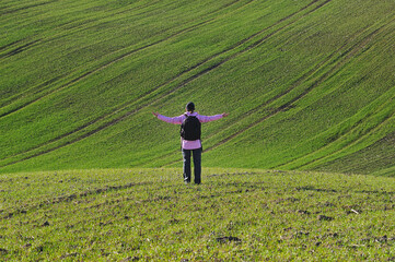 Tourist enjoys the rural landscape. Hills and farmland