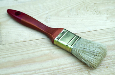 Painting brush for oil paint on a wooden table