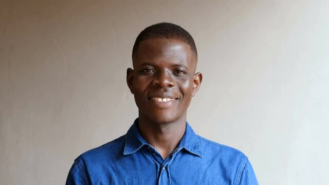 confidence, positivity-young african man looking at camera and smiling