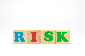 Multicolored cubes on white background word risk