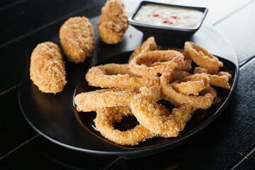 Beer snacks. Breaded meat appetizer and onion rings.
