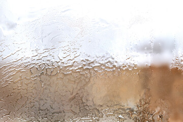 Frosty patterns on window glass in winter close up