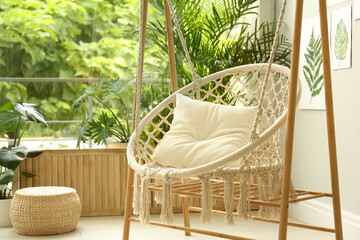 Comfortable hammock chair in stylish room. Home interior