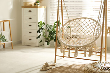 Fototapeta na wymiar Comfortable hammock chair in stylish room. Interior design