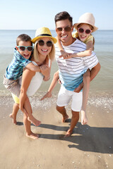 Happy family at beach on sunny summer day