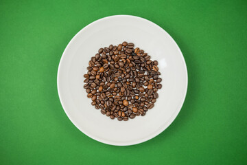 Roasted coffee beans in a white plate