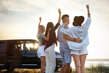 Group of friends near car outdoors. Summer trip