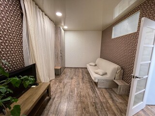 stylish light sofa in wood room'