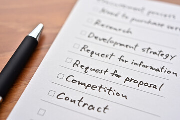 There's a piece of paper on the desk with a "procurement process" checklist. It is focus in Competition.