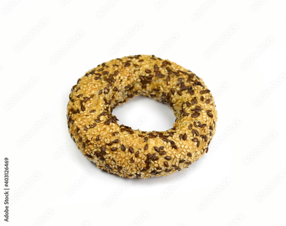 Poster Fullgrain bagel with seeds isolated on white background. Fresh breakfast bread bagel roll with seeds isolated on white background.