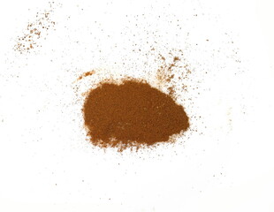 Spice cinnamon powder isolated on a white background. Cinnamon powder spilled on a white surface.