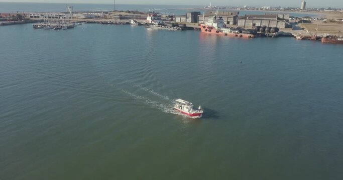 Aerial view of a sport fishing boat sailing in the port.
