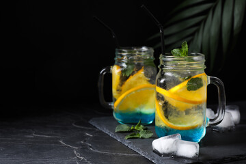 Delicious refreshing drink on black table. Space for text