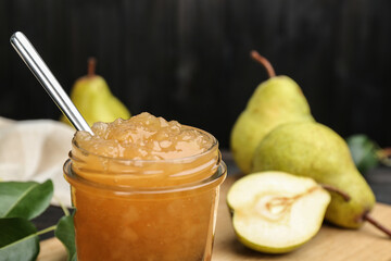 Delicious pear jam in glass jar, closeup. Space for text