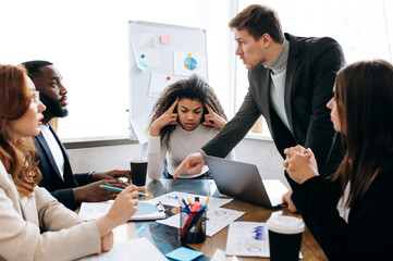 Corporate business negotiations. Frustrated group of multiracial people argue at briefing meeting,...