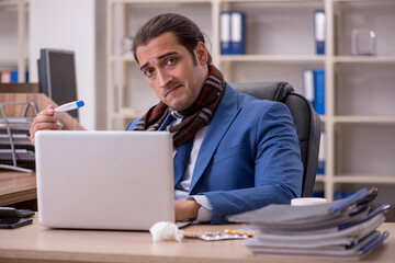 Young sick businessman employee suffering at workplace