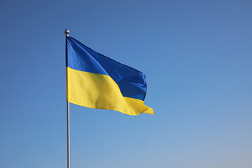 National flag of Ukraine against blue sky