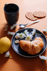 Croissant with biscuits, lime and tea. Breakfast with tea and croissant