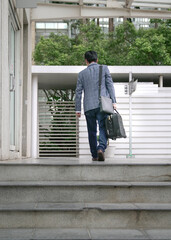 Businessman cum traveler with suitcase and bag