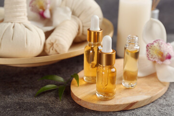 Fototapeta na wymiar Beautiful spa composition with essential oils on grey table, closeup