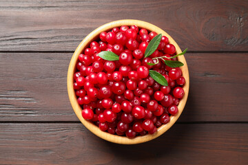 Fresh cranberry on wooden table, top view