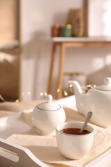 Fototapeta na wymiar Ceramic tea set on white tray in room