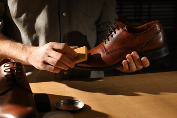 Master taking care of shoes in his workshop, closeup