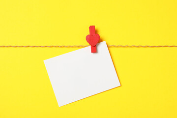 Blank card on yellow background, top view with space for text. Valentine's Day celebration