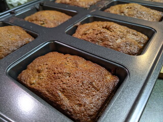 Small loafs of Candied fruit cake in baking tray.