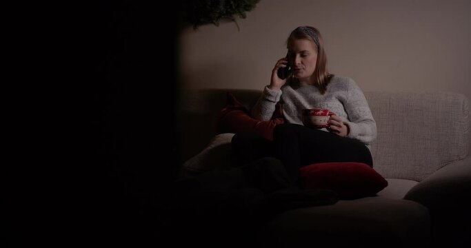 Woman Talking on Mobile at Evening in Living Room