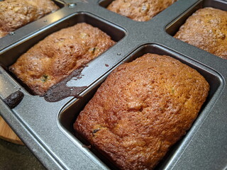 Small loafs of Candied fruit cake in baking tray.