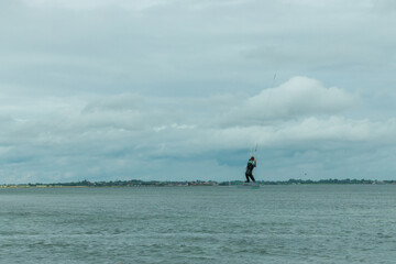 kitesurfer flies across the sky of the North Sea in Germany