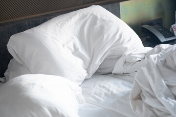 Messy white bed and pillow.